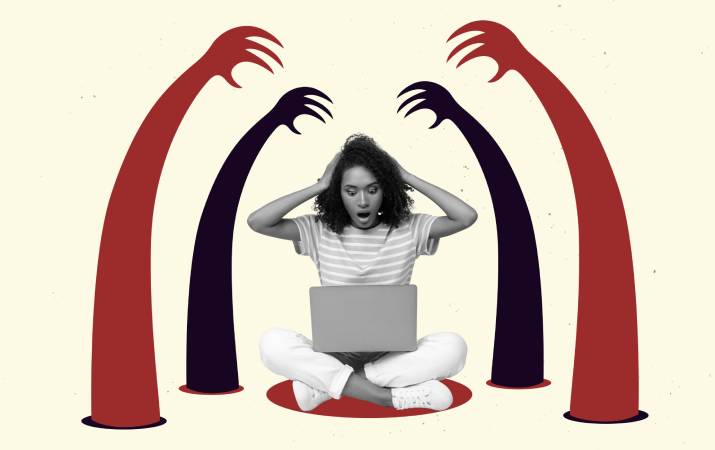 A woman holding her hands over her head surrounded by looming monster hands